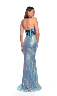A woman stands facing away, wearing the Dave and Johnny 12036 long prom dress—a strapless, floor-length blue gown with a fitted corset bodice and shimmering patterned details.