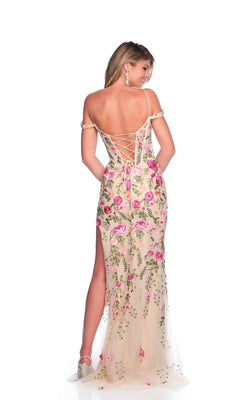 A woman models the Dave & Johnny 12097 long prom dress with an off-the-shoulder lace-up corset bodice and floral embroidery, turned to display the gown’s back against a white background.