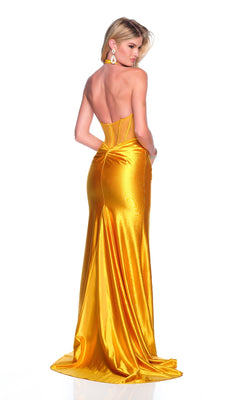 A woman stands against a white background, facing away, wearing the Dave & Johnny 12133 long yellow prom dress with a strapless sheer corset bodice and large drop earrings.