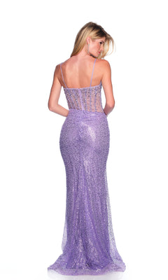 A woman models the Lilac Sequin Prom Dress: Dave & Johnny 12147, a fitted, floor-length gown with a sheer corset bodice, thin straps, and sparkly lilac sequins, standing against a white background.