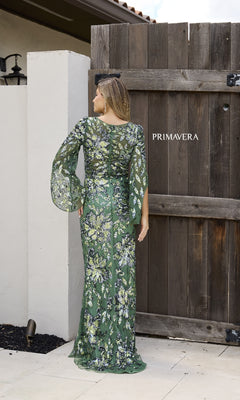 A woman wearing the Primavera 12171 long formal dress in green, featuring sheer long sleeves.