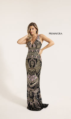A woman models the Primavera 12177 Long Formal Dress, a black sleeveless gown with gold and pink beadwork, against a plain white background. "PRIMAVERA" is displayed beside her.