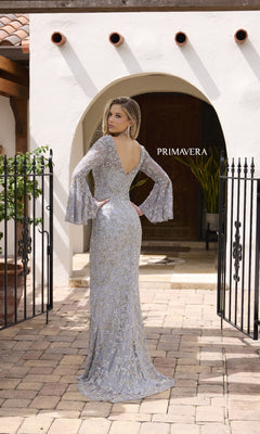 A woman wearing the Primavera 12185 long formal dress, featuring intricate beading and a v-neckline.