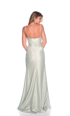 A woman stands facing away against a white background, wearing the Dave and Johnny 12190 long prom dress—a fitted, light silver, floor-length gown with thin straps and a low back.
