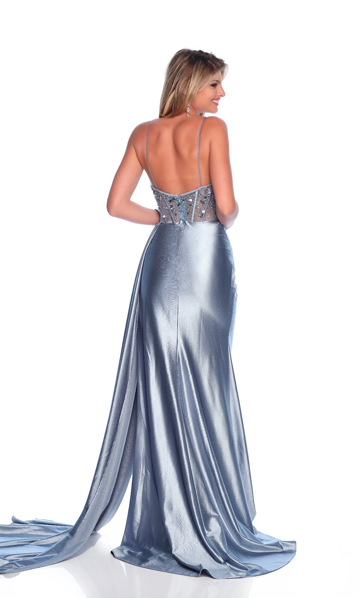A woman faces away, wearing the Light Blue Prom Dress: Dave & Johnny 12263—a backless gown with thin straps and a long, flowing train—set against a white background.