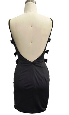 The Backless Black Hoco Dress: 12387 is a sleeveless mini dress with a deep V-shaped open back and decorative side bows—a chic choice for your next cocktail event.