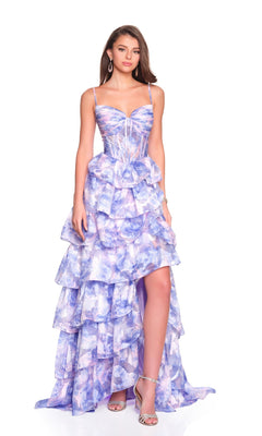 A woman stands against a white background wearing the Dave and Johnny 12400 long prom dress, featuring a lilac and white floral print, corset bodice, spaghetti straps, and a high-low hem.