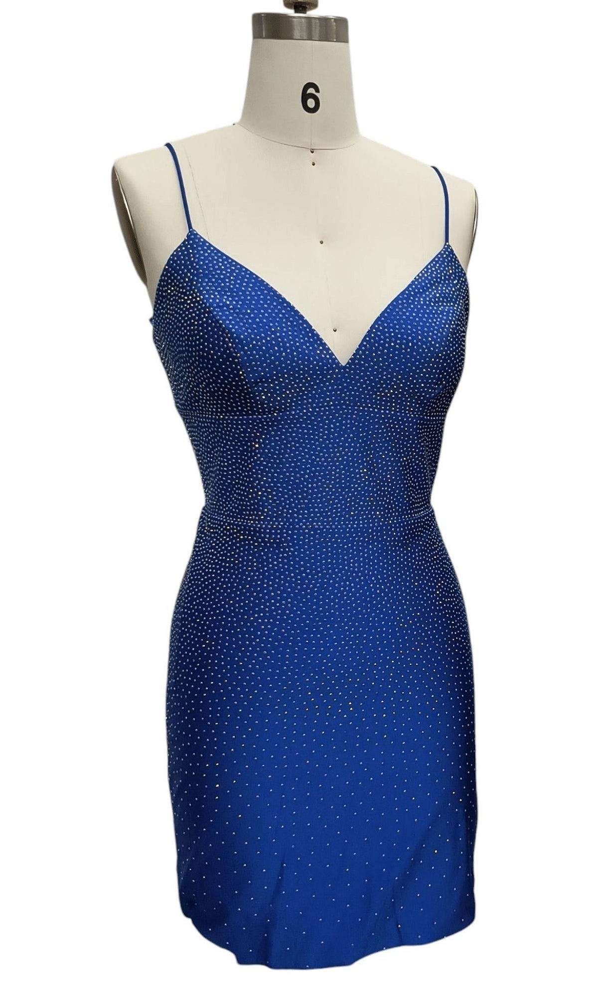 The Beaded Short Hoco Dress: 12417 is a royal blue, sleeveless rhinestone cocktail dress with thin spaghetti straps and sparkling embellishments, showcased on a dress form labeled 6.