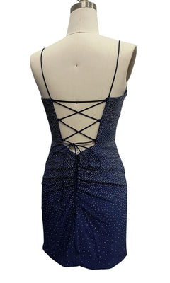Beaded Short Hoco Dress: 12417, a navy blue mini dress with white polka dots, ruched details, and crisscross lace-up open back, displayed on a dress form.