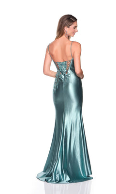 A woman models the Dave and Johnny 12428 long prom dress in shiny teal satin, featuring thin straps and a lace-up back, standing against a plain white background with her back to the camera.