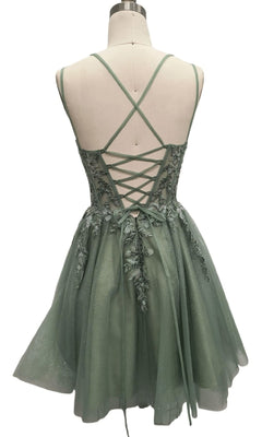 The Short Sage Green Hoco Dress: 12435 features a sleeveless design, lace-up back, crisscross straps, floral embroidery, and a layered tulle skirt—an elegant choice for your next designer party look.
