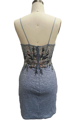 A mannequin displays the Short Blue Homecoming Dress: 12442, featuring a sequin-embellished back view with thin straps and floral embroidery on the bodice.