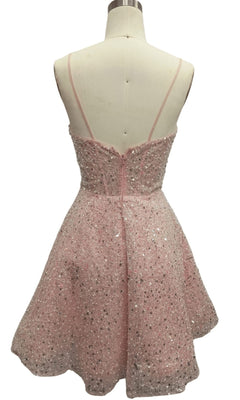 Back view of Short Pink Sequin Hoco Dress: 12461 with thin straps and silver sequin accents, displayed on a dress form.