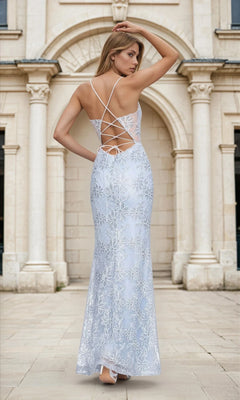 A woman wearing the Backless Sky Blue Floral Long Prom Dress L472 stands outdoors in front of a stone building with arches.