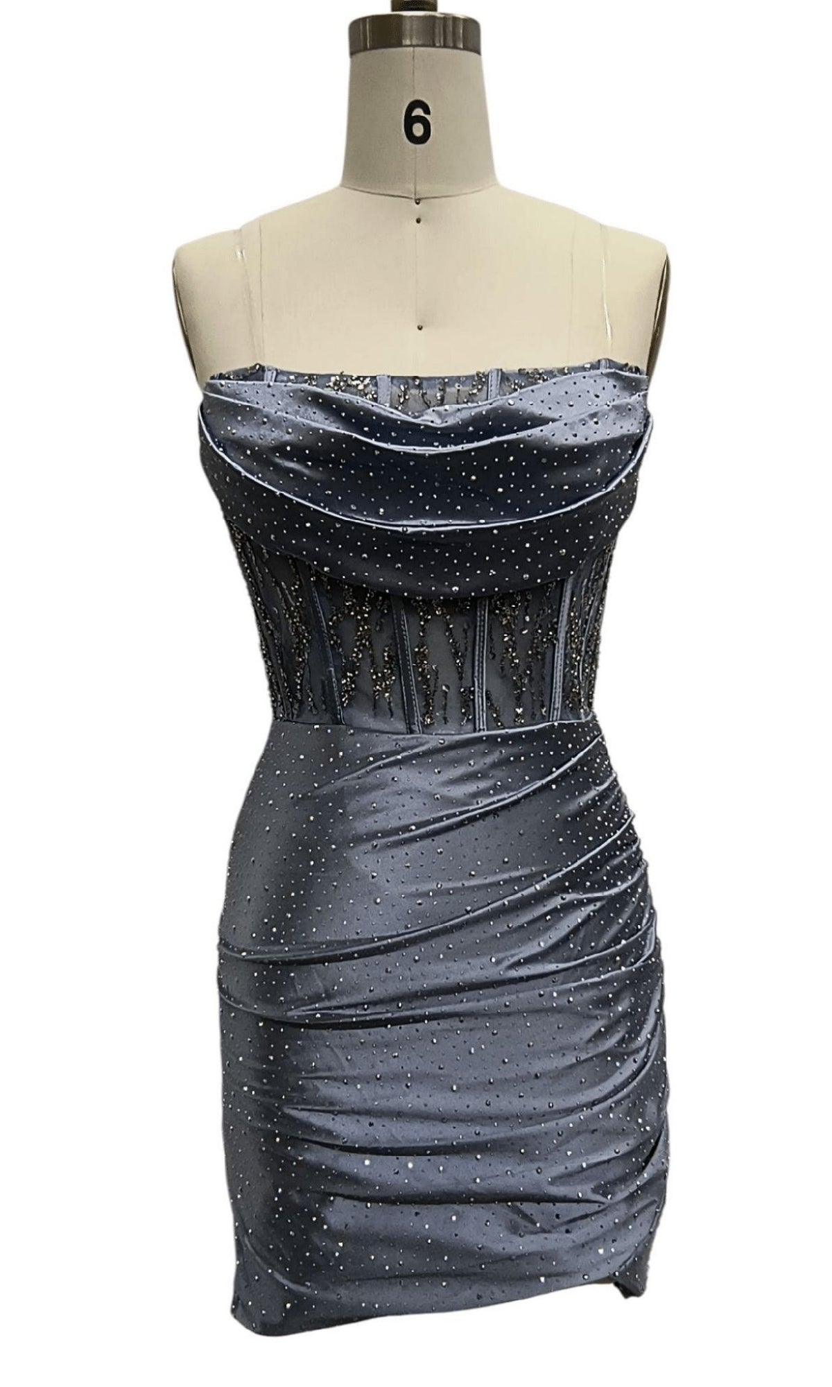 A strapless, fitted blue mini party dress—Strapless Blue Hoco Dress: 12482—features a beaded ruched skirt and sheer sparkly corset bodice, displayed on a dress form.