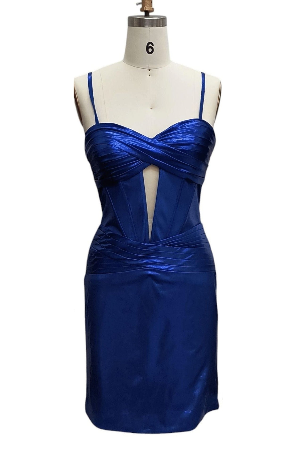 Cut-Out Short Metallic Hoco Dress 12512: a royal blue satin party dress with spaghetti straps, sweetheart neckline, corset-style bodice, front ruching, and a geometric cutout at the front, shown on a dress form.
