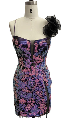 A mannequin displays the Short Purple Sequin Hoco Dress 12567, a dazzling strapless mini with sequin details, a sheer central panel, side slit, and an eye-catching floral accent on one shoulder.