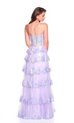 A woman faces away in the Dave and Johnny 12636, a light-purple long prom dress with floral details, lace-up back, spaghetti straps, and a tiered tulle skirt that creates an elegant silhouette.