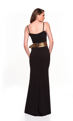 A woman stands with her back to the camera, wearing the Dave and Johnny 12666 long black prom dress with thin straps, a shiny gold belt, and a sleek sheath skirt, set against a plain white background.