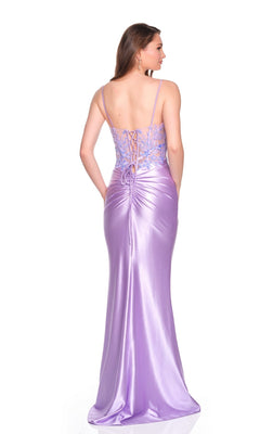 A woman faces away, wearing the Dave and Johnny 12673 long prom dress—featuring shiny purple fabric, spaghetti straps, an embroidered corset bodice, and a satin sheath skirt draping elegantly to the floor.