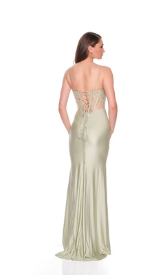 Woman modeling the Dave and Johnny 12704 long prom dress in light green, with a floor-length sheath skirt, thin straps, and lace-up back, standing against a plain white background.