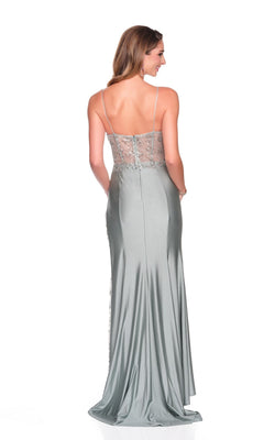 A woman faces away against a white background wearing the Dave and Johnny 12715 long prom dress in silver-gray, featuring thin straps, an embellished corset bodice, and a sheer back.