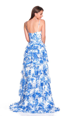 A woman stands facing away against a plain white background, wearing the Dave and Johnny 12723 long prom dress—a blue and white floral tiered chiffon gown with spaghetti straps.