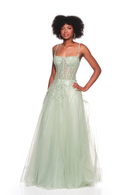 A woman poses with one hand on her hip, wearing the Dave and Johnny 12907 long prom dress in light green, featuring an embroidered bodice and a flowing A-line tulle skirt against a white backdrop.