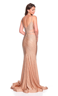 A woman stands facing away, wearing the Long Prom Dress: Dave and Johnny 12909—a floor-length champagne gown with thin straps, an open back, and sparkling beaded embellishments.