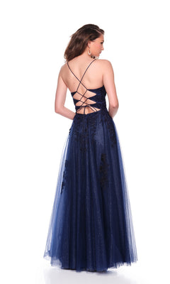 A woman stands with her back to the camera against a white background, wearing the Dave and Johnny 12935 long prom dress—a floor-length navy blue gown featuring a lace-up corset bodice and tulle overlay.