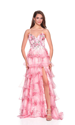 A woman models the Dave and Johnny 12941 long prom dress featuring a beaded satin corset bodice, thin straps, ruffled details, and a high-slit chiffon A-line skirt in pink, standing against a white background.