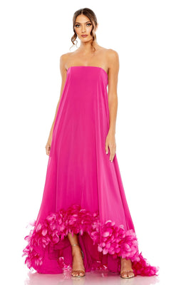 A woman models the Strapless Trapeze Formal Gown: Mac Duggal 13001, a bright pink, long strapless dress with feathered hem—an elegant evening gown perfect for prom—posed against a white background.