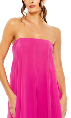 A woman wears the Strapless Trapeze Formal Gown: Mac Duggal 13001 in bright pink, shown from shoulders to mid-thigh with her hands in the dress pockets.