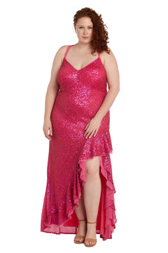 A woman in the Long Plus-Size Sequin Prom Dress: Morgan 13029WM, featuring hot pink sequins, a high slit, v-neckline, and ruffled hem, stands facing the camera with curly red hair and nude heeled sandals.