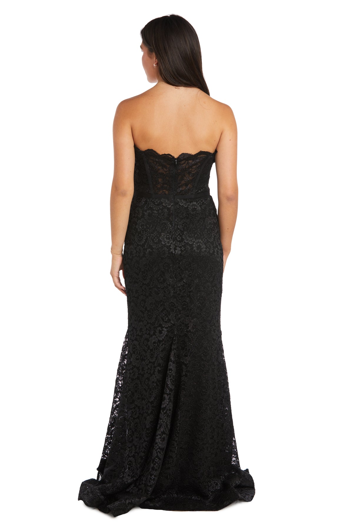 A woman stands with her back to the camera, wearing the Strapless Long Lace Prom Dress: Morgan 13269—a floor-length black lace mermaid gown with a slight train.