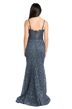 A woman with long dark hair wears the strapless Morgan 13269 long lace prom dress and stands facing away from the camera against a white background.