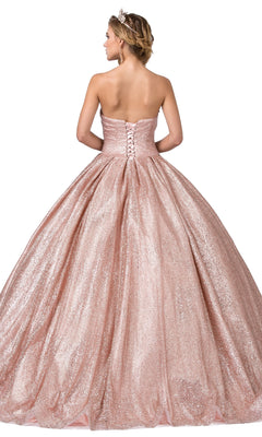 A woman stands facing away from the camera wearing the Quinceanera Dress 1341 by Dancing Queen—a strapless, sweetheart neckline ball gown in sparkling pink with a lace-up back.