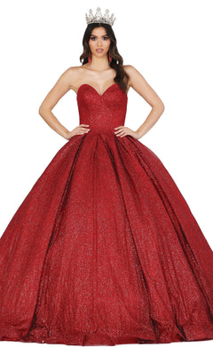 A woman wearing the Quinceanera Dress 1341 by Dancing Queen—a sparkling red ball gown with a strapless sweetheart neckline and a silver crown—stands with her hands on her hips against a white background.