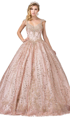 A woman in the Quinceanera Dress 1397 by Dancing Queen—a sparkling, ornate blush pink A-line ball gown with gold embellishments, cap sleeves, and a tiara—stands against a white background.