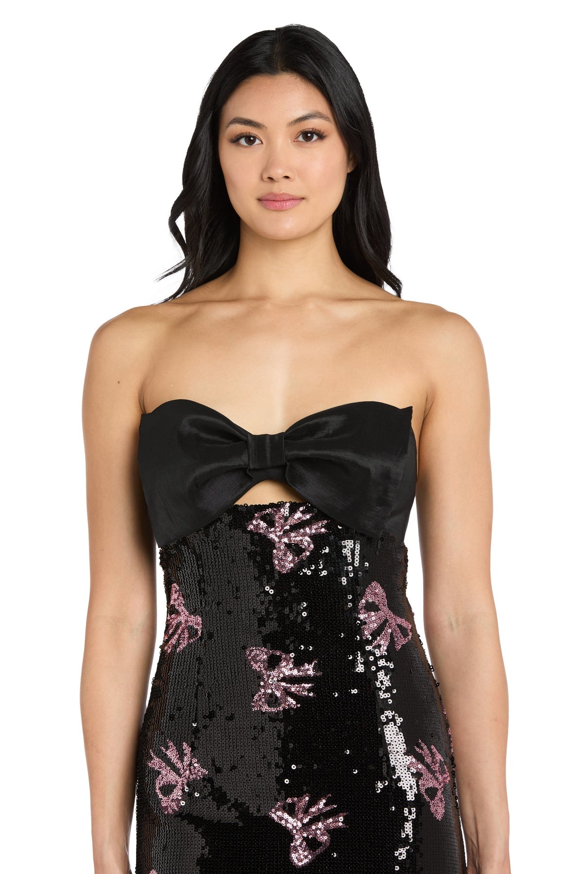 Black strapless dress with pink bow sequin details worn by a model on a white background