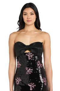 Black strapless dress with pink bow sequin details worn by a model on a white background