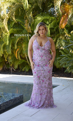 A woman wears the Plus-Size Beaded Prom Gown: Primavera 14071 in lavender floral, standing on a white patio by a pool with lush greenery behind her and "PRIMAVERA" displayed in the scene.