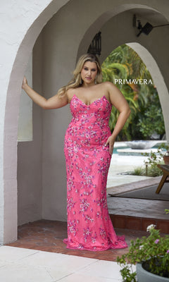 A woman in the Primavera 14080 Long Plus-Size Prom Dress stands under an archway with one arm resting on the wall, with "PRIMAVERA" visible in the background.