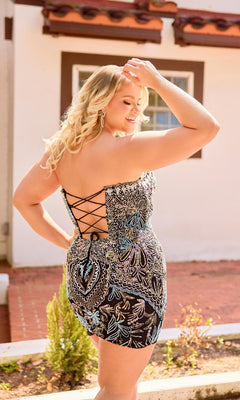 Woman wearing a patterned dress with a back detail, standing outdoors.