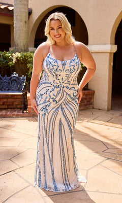 A woman in the Primavera 14101 long plus-size prom dress in ivory blue, featuring a sleeveless beaded design with blue sequins and a lace-up strappy back, stands smiling on a stone patio.