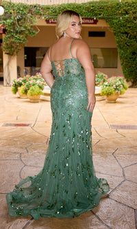 A woman in the Primavera 14106 Long Plus-Size Prom Dress, a green floor-length sequin gown with lace-up back detail, stands on a patio facing away from the camera.