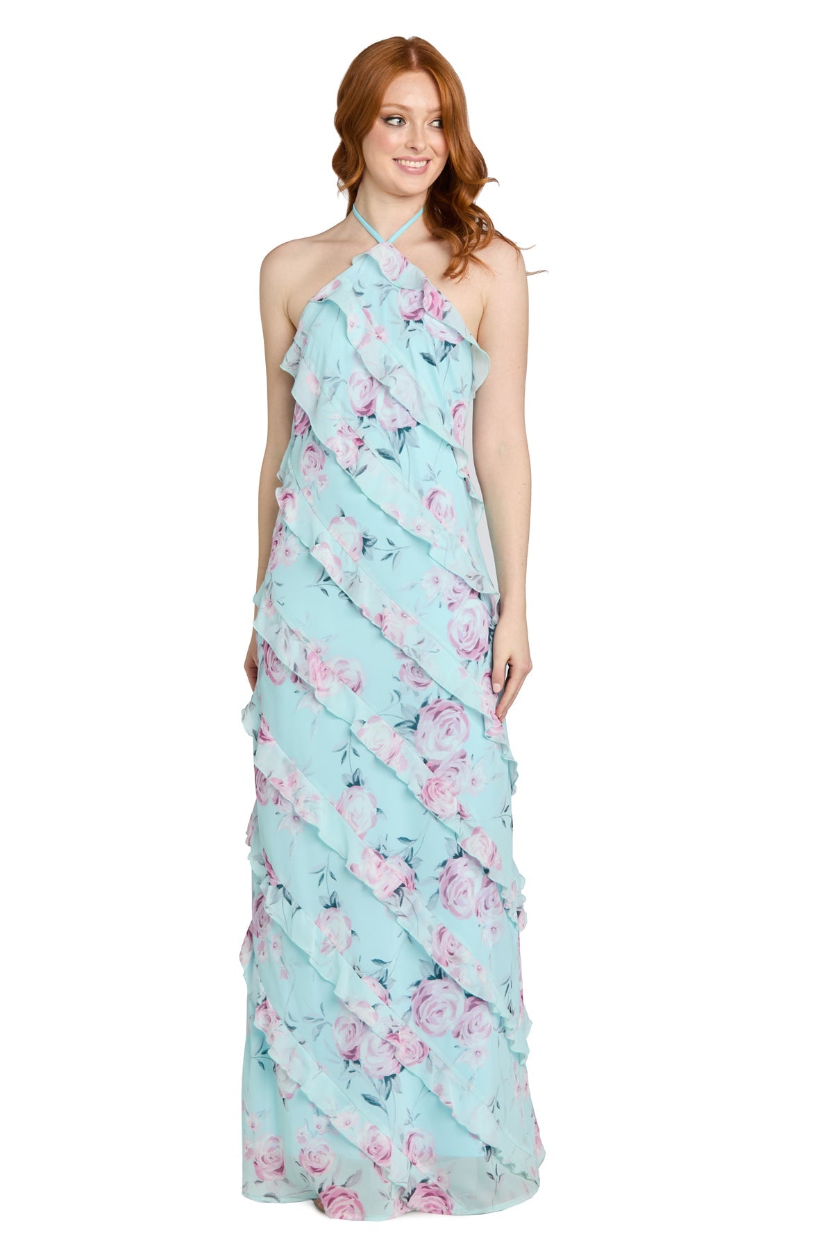A woman wearing the Floral Ruffled Maxi Dress: Morgan 14173, a light blue halter-neck maxi dress adorned with pink floral patterns and ruffle tiers, stands against a white background.