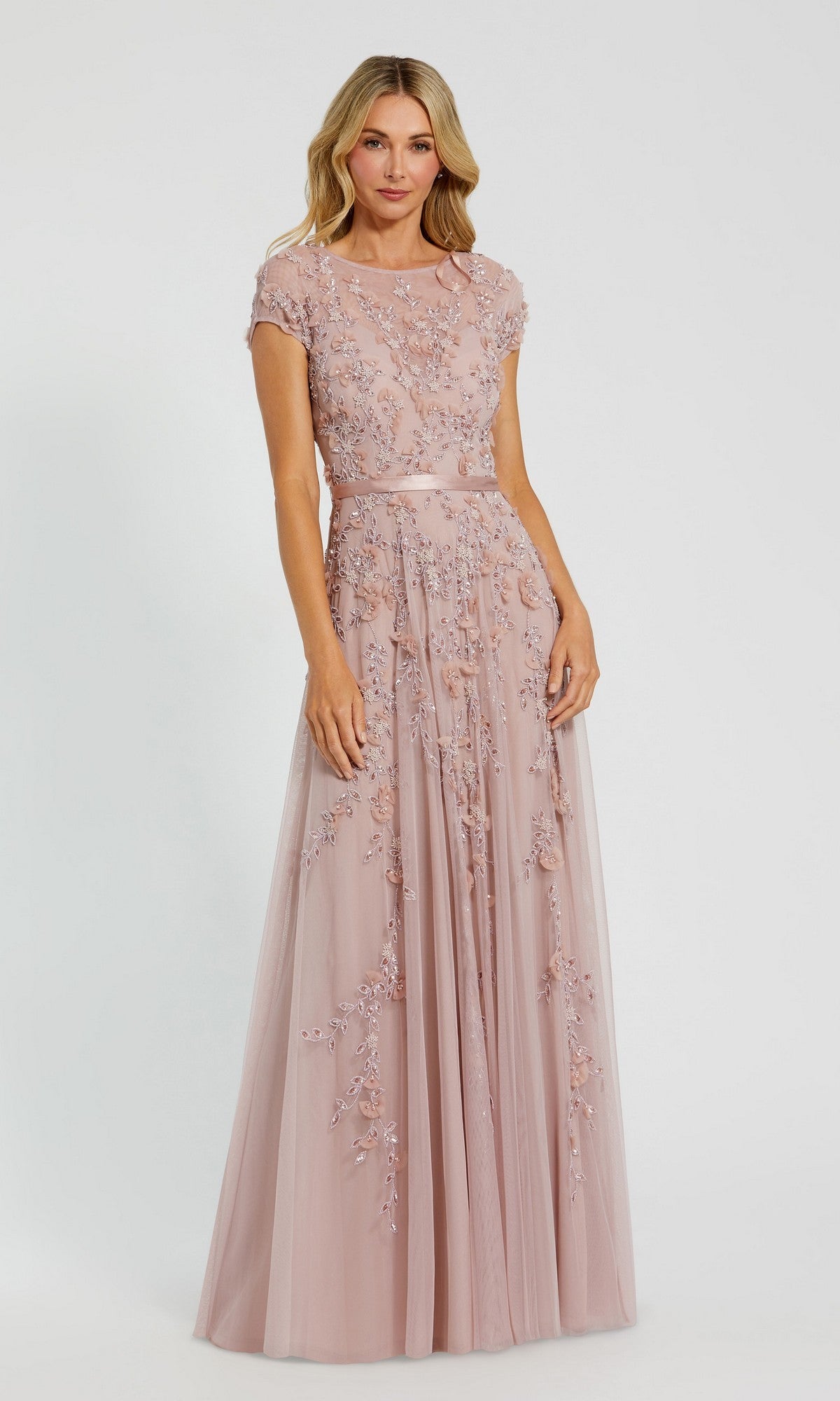 A woman wearing a floor-length, sky blue Mac Duggal 14521 formal dress stands against a plain light background.