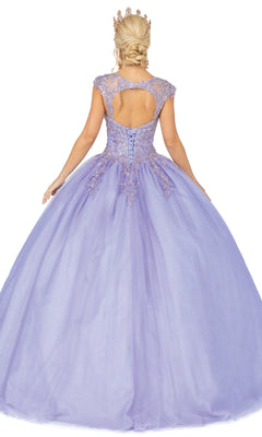 A woman in the Quinceanera Dress 1470 by Dancing Queen stands facing away, showing off its lavender hue, lace details, open back, and full skirt, crowned for a regal look.