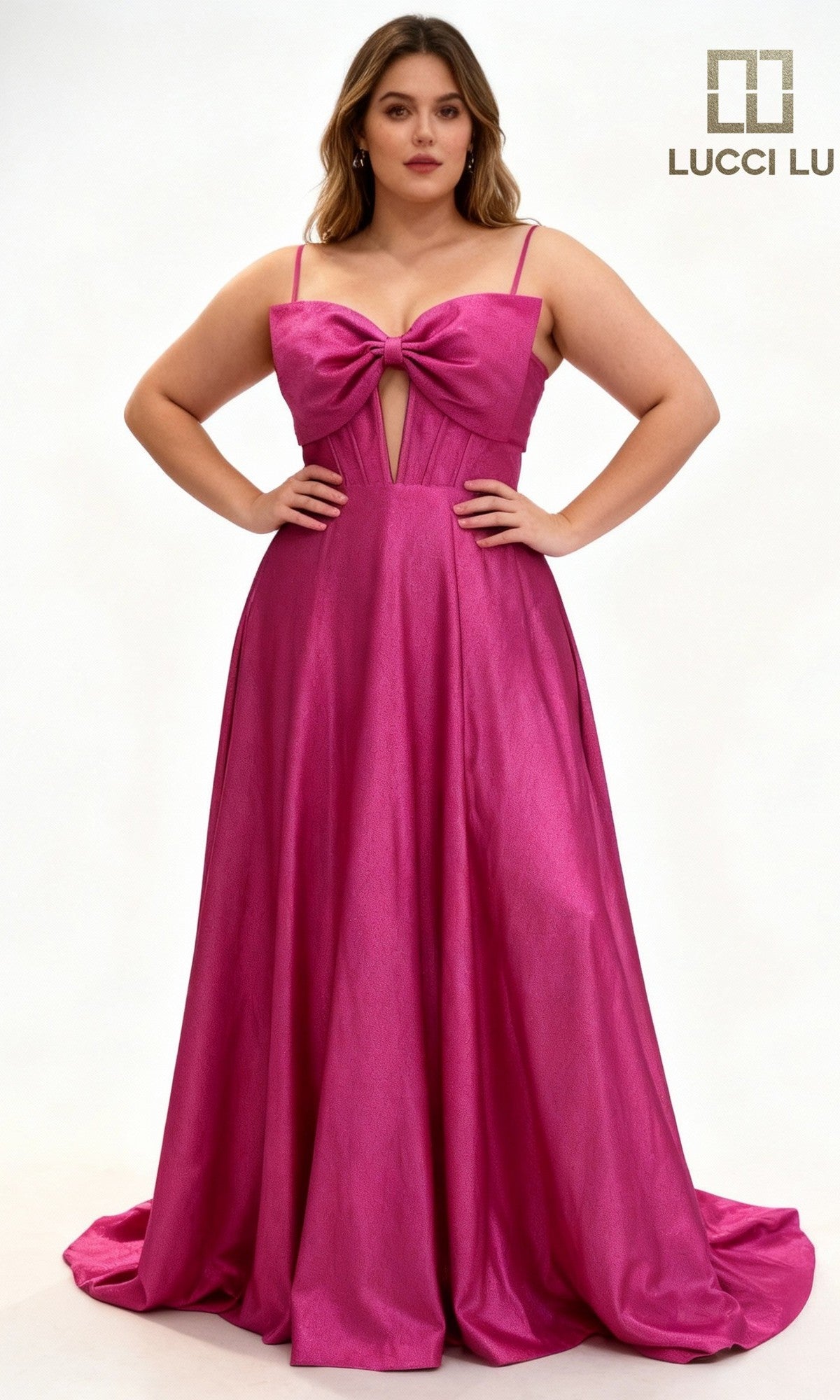A woman models the Lucci Lu 1477, a sleeveless, floor-length fuchsia satin prom dress with a corset bodice and large bow, standing against a plain background. The Lucci Lu logo appears in the top right corner.
